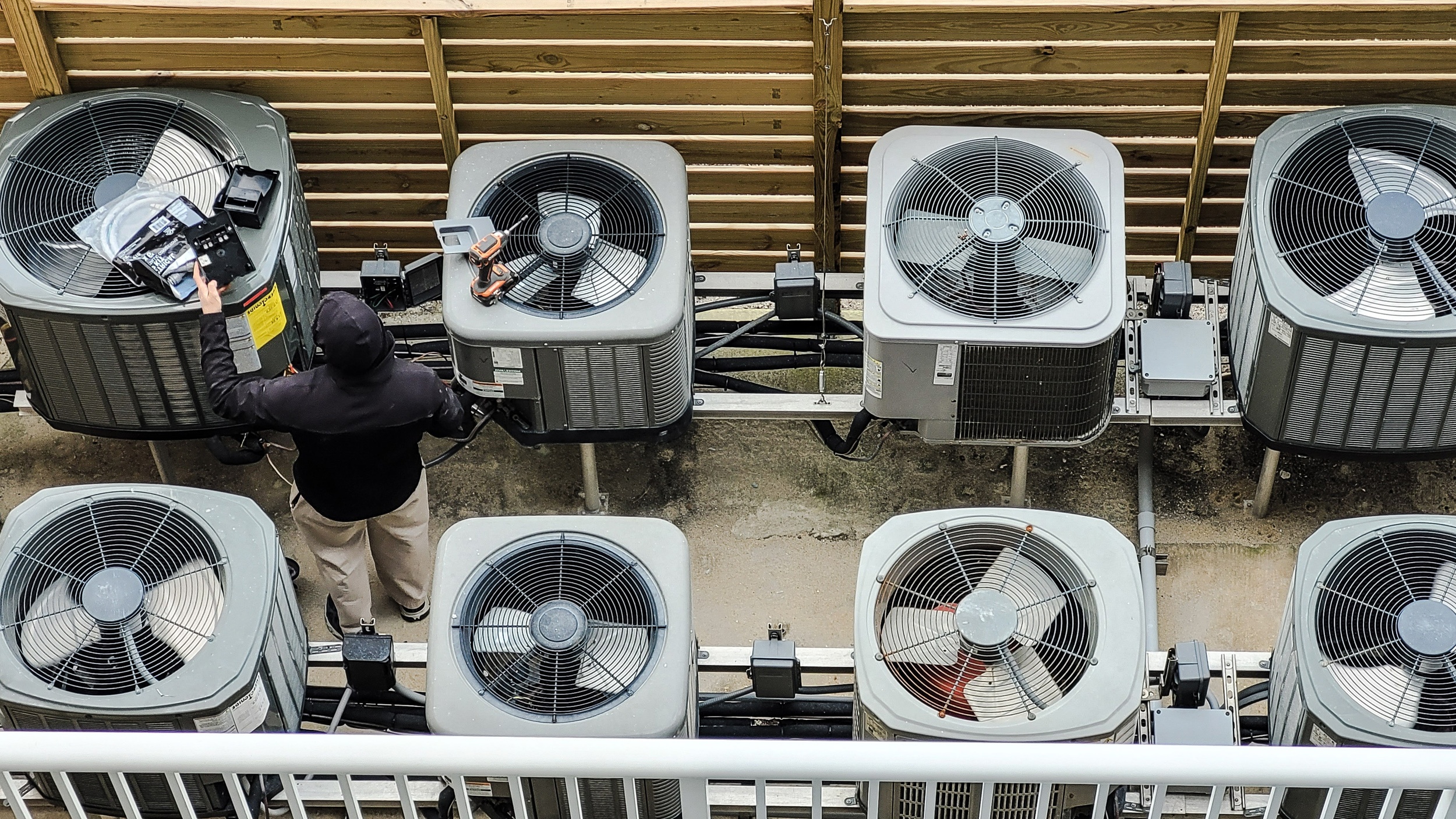 worker-from-behind-analyzing-each-condo-appliance-2021-06-14-18-26-10-utc2500px